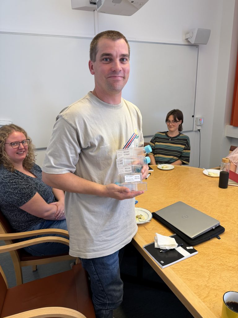 Niklas holding the TiDE football betting tournament trophy.